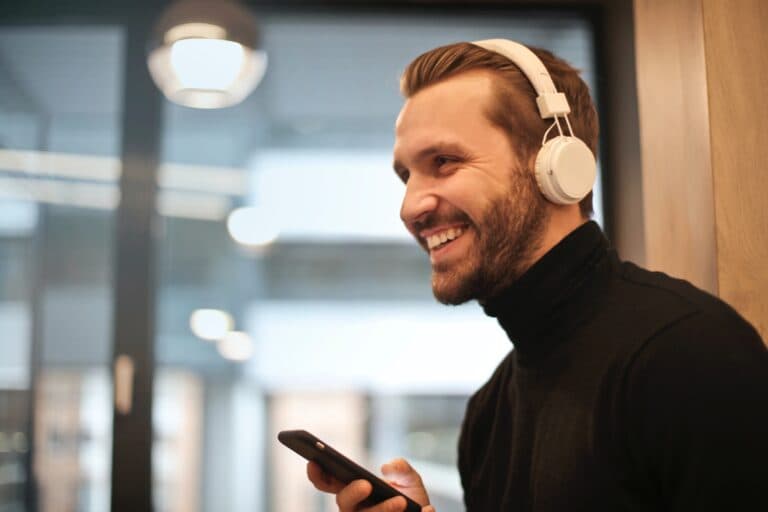 Man Wearing White Headphones Listening to podcast