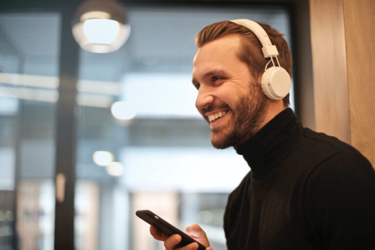 Man Wearing White Headphones Listening To Podcast